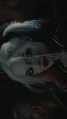 a woman with white hair and black makeup