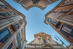 looking up at an old church tower from the ground down on it's sides