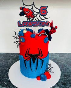 a spiderman birthday cake with the number 5 on it's top and decorations