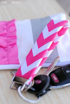 a pink and white chevron keychain sitting on top of a table