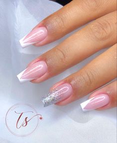 a woman's hand with pink and white nail polish