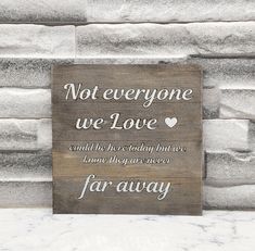 a wooden sign that says not everyone we love and the words below it are written in cursive writing