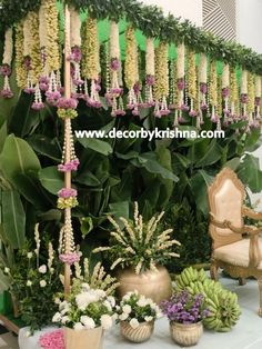 an arrangement of flowers and greenery on display at a wedding ceremony or reception venue