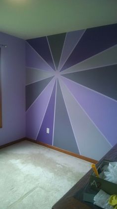 an empty room with purple walls and white carpet