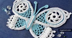 a crocheted blue and white butterfly with beads on it's back end