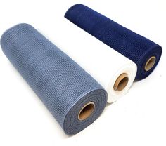 two rolls of blue and white fabric on top of each other