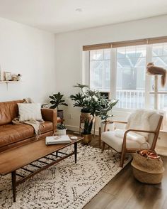 a living room filled with furniture and a large window