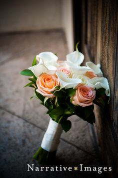 a bouquet of flowers sitting on top of a wooden door