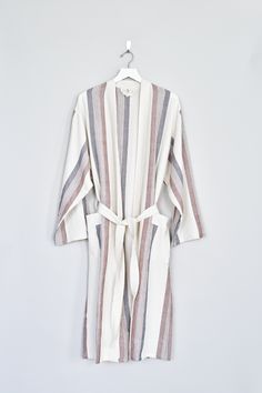 Crafted on the coast of Turkey, our Brown/Cream Hudson Long Robe is hand loomed using traditional techniques and woven with 100% premium Turkish cotton. Similar to a Turkish towel, it is highly absorbent, lightweight, eco-friendly, and quick to dry. Lounge in your robe by the sea or layer it over a lightweight dress. Experience how your robe becomes softer and better with each and every wash! Care - Machine wash cold. Tumble dry low or line dry. Sizing - Small: 46" L, ~25" W , Medium: 46" L, ~27 Spring Cream Cotton Robe, Beige Long Sleeve Cotton Robe, Bohemian V-neck Robe For Loungewear, Brown Bath Robe, Cotton Bathrobe, Lightweight Dress, Sleepwear & Loungewear, By The Sea, Traditional Techniques