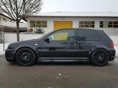 a black car parked in front of a building