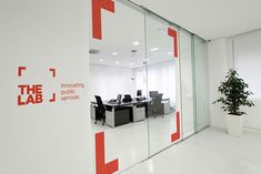 an office with glass walls and red letters on the wall that says the lab j