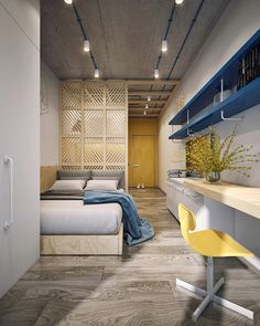 a room with a bed, desk and shelves on the wall next to each other