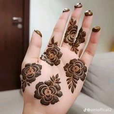 a woman's hand is decorated with hendi and flower designs on her hands