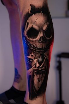 a man's leg with a skeleton tattoo on it