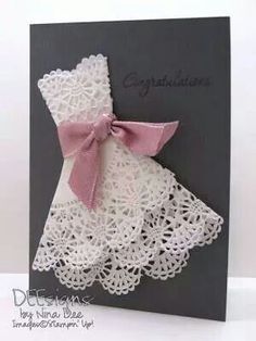 a card with a pink bow on it's neck and white crochet