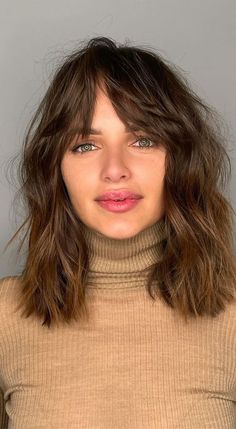 30 Medium Length Haircuts 2022 For All Face Shapes : Textured Long Bob with Bangs Texture Mid Length Hair, Med Length Hair With Bangs Medium Layered, Mid Length Fringe Haircut, Fringe Layered Hairstyles, Medium Fringe Haircut Shoulder Length, Mid Length With Fringe Hair Styles, Round Face Lob With Bangs, Choppy Mid Length Hair With Fringe, Wavy Bob Long Bangs