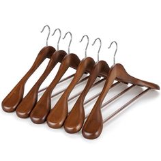 four wooden hangers with metal clips hanging from the top and bottom of them on a white background