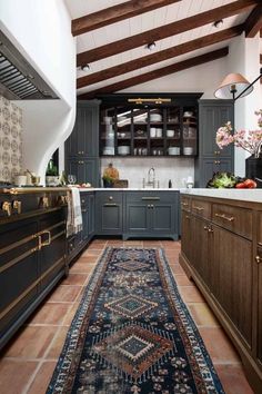 a kitchen with an area rug on the floor