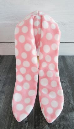 the pink and white polka dot oven mitts are folded on top of each other