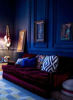 a living room filled with furniture and blue walls