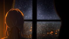 a woman looking out the window at night