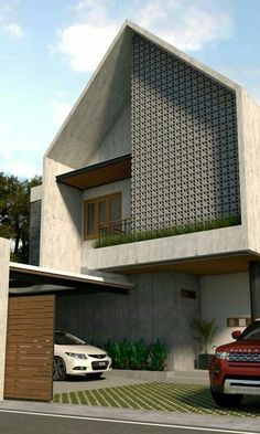 two cars are parked in front of a house with an unusual design on the roof