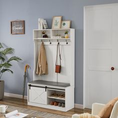 a living room with blue walls and a white coat rack filled with coats on it