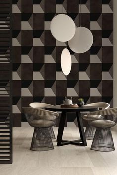 a dining room with black and white geometric wallpaper