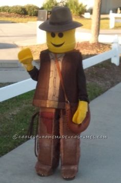 a person in a costume that looks like a lego man with a hat and cane