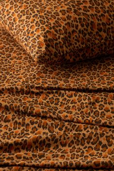 an animal print sheet set on top of a bed