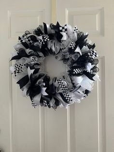 a black and white wreath hanging on the front door