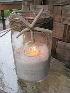 a mason jar with twine on the lid and rope wrapped around it, sitting on top of a table