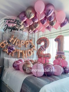 balloons and streamers in the shape of numbers on a bed