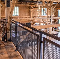 the inside of a building with wooden walls and metal railings