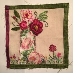 a close up of a piece of cloth with flowers on it and green trim around the edges