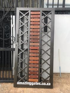 an iron gate with wooden slats on it