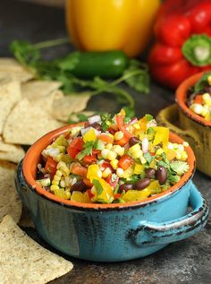 two bowls filled with salsa and tortilla chips