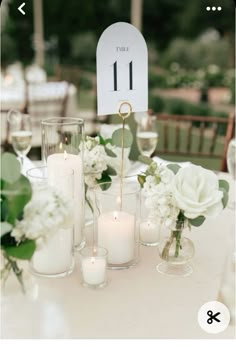 the table is set with candles, flowers and place cards for guests to sit at