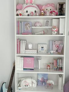 a white book shelf filled with lots of toys