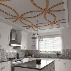 a large kitchen with white cabinets and black counter tops, an island in the middle