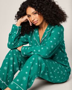 Admire wintry snowflakes without feeling any chill in the air. Flurries cover a striking emerald green flannel background, making this set a cozy hit for any holiday moment. This classic pajama set is accented with white piping and finished with logo buttons. The fabric is made from 100% of the finest quality cotton. It is yarn-dyed to prevent fade and brushed for added softness making the sleepwear feel absolutely luxurious, getting cozier after each wash. Green Winter Lounging Sleepwear, Green Long Sleeve Sleepwear For Holiday, Green Winter Sleepwear Sets, Casual Green Holiday Sets, Green Long Sleeve Holiday Sleepwear, Holiday Green Long Sleeve Sets, Green Winter Holiday Sets, Casual Green Christmas Sets, Green Holiday Sets For Winter Season