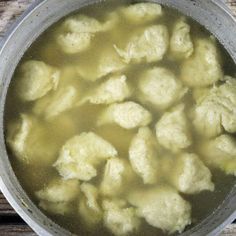 cauliflower and broth in a pot on a wooden table, ready to be cooked