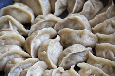 some dumplings are sitting in a blue bowl