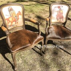 two chairs that have been painted with horses and cowboys on them, sitting in the grass