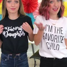 two young women standing next to each other with their hands in the air and one has her mouth open