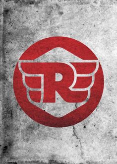 a red and white logo with the letter r in it's center on a concrete surface