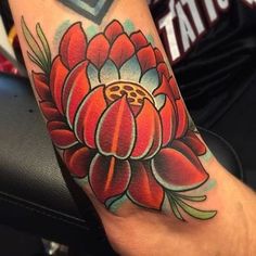 a colorful flower tattoo on the arm