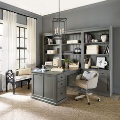 a home office with gray walls and furniture