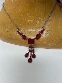 A sweet red bead choker necklace. with metal links. Nice shapes which lead to three pieces to fall at throat. It's on a double chain to add to the appearance.  Suitable for all ages. It has a safe clasp. There is an extension chain as well to fit most. A nice dress up or costume piece. It measures 19 cm and extends to 27cm with extra chain long and is in good condition. The lovely drop of beads at the bottom is nearly 7cm. Very pretty. Piece of costume jewellery I am a trusted vintage dealer bas Red Dangle Necklaces For Party, Red Metal Necklaces For Party, Red Metal Dangle Necklace, Vintage Red Choker Necklace, Red Vintage Choker Necklace, Red Dangle Necklaces With Lobster Clasp, Red Chain Choker Necklace, Red Metal Chain Necklace As Gift, Red Choker Necklace With Lobster Clasp