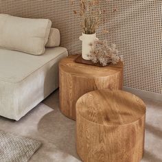 a living room scene with focus on the coffee table and stools in front of the couch